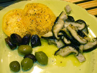 eating On the plate with a few olives and yellow tomato